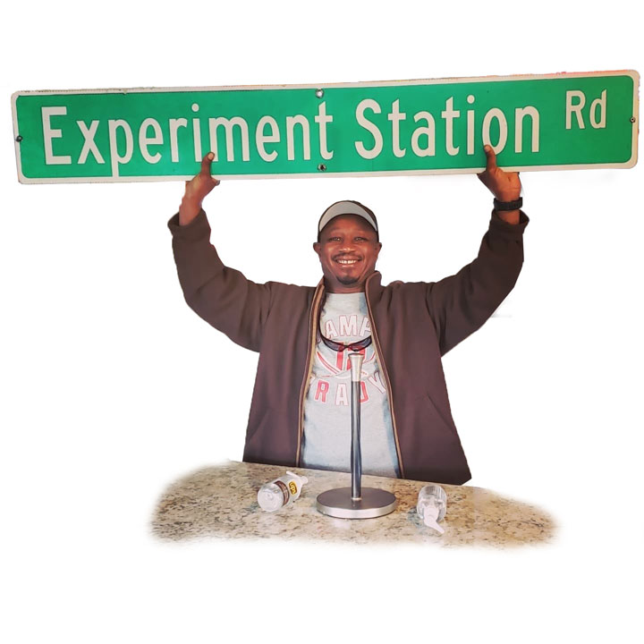 Chef Bobby Jones holding a street sign